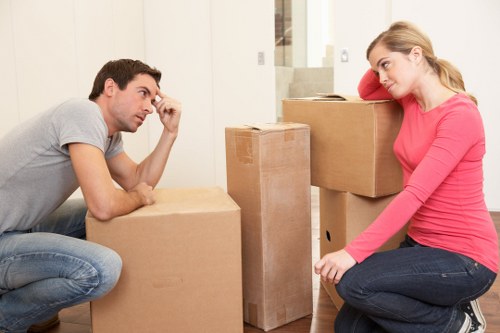 Packed moving boxes and wrapped furniture ready for transport