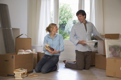 Professional movers handling household furniture and boxes